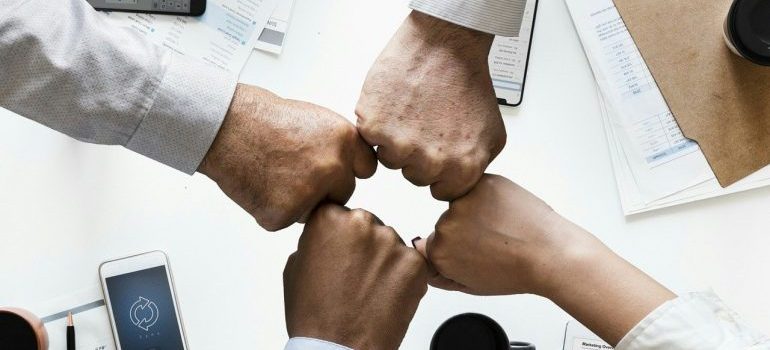 A group of people bumping hands.